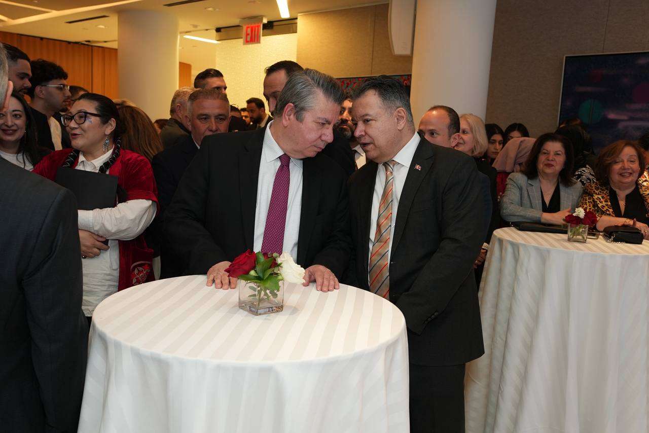Officials greeting guests at a reception table