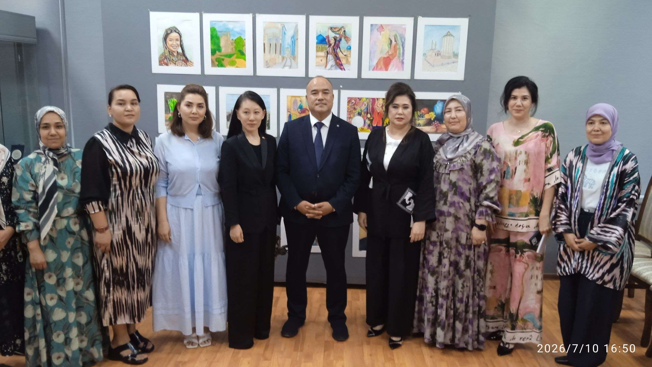 Visitors and hosts in formal and traditional dress at an anniversary gathering